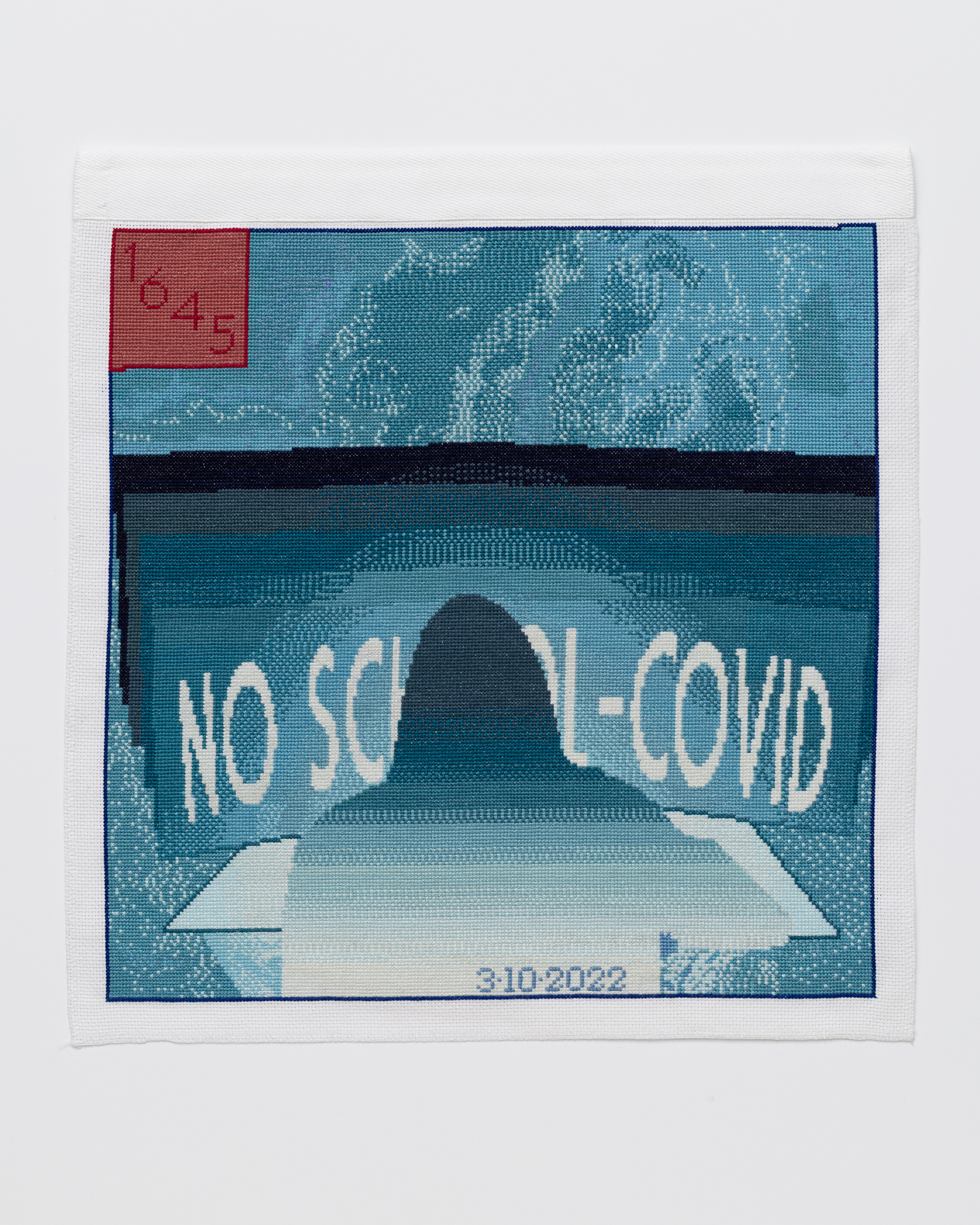 Mar 10, 2022 Cross stitch embroidery of back of person with long hair sitting at a desk, in front of a screen. On the screen is written "NO SCHOOL-COVID" The embroidery is varying colors of blue/teal, with a red square in the upper left corner. "3/10/2022" is written across the bottom middle of the image.