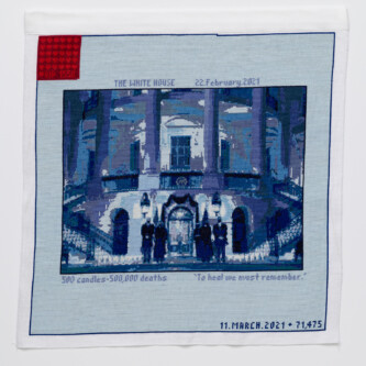 Cross stitch embroidery of picture of President Biden in front of the White House, standing with other figures, stitched in blue threads. There is a solid light blue border around the image, with "THE WHITE HOUSE 22.February.2021" written above, and "500 candles- 500,000 deaths To heal we must remember." written below. There is a red square in the upper left corner.